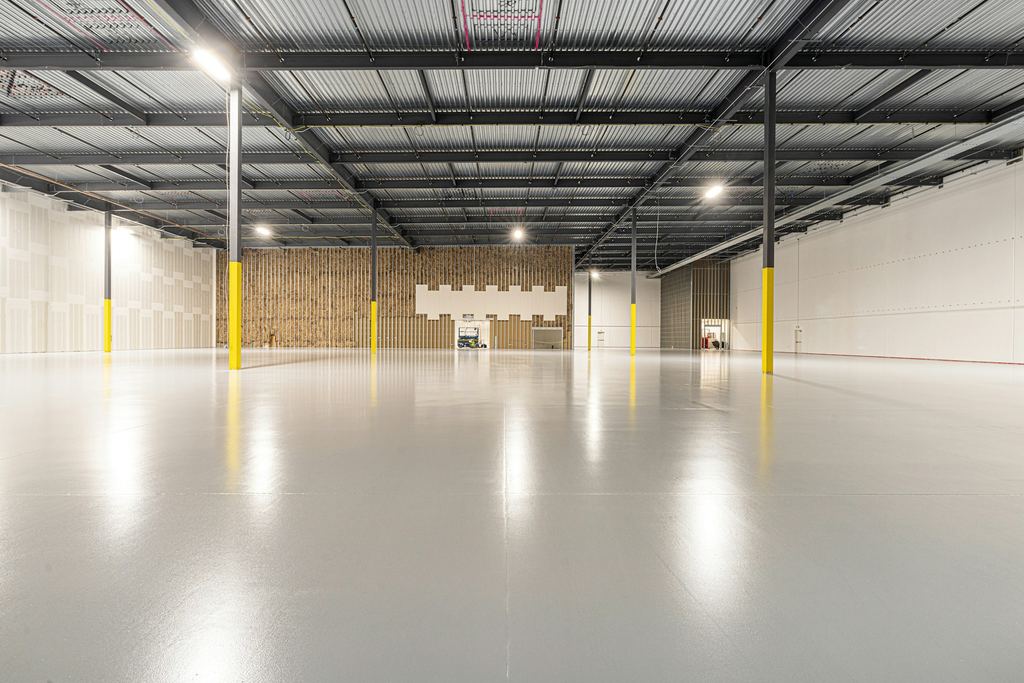 Clean, empty modern industrial interior used as atmospheric trade-gateway imagery, not a depiction of real TerraGate premises