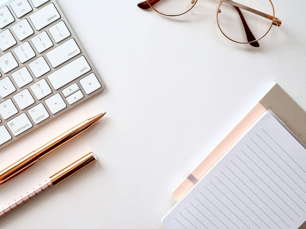 Planning notes and desk items, representing product sourcing review